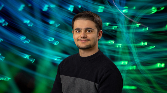 A photo of the EDC's Graduate Energy Data Steward with a background of glowing keyboard keys