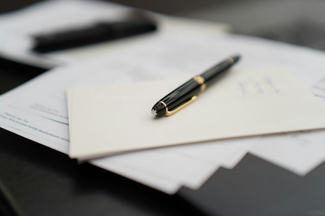 A photo of a pen on top of some documents