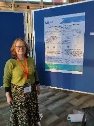 A photo of the EDC lead Catherine Jones presenting the EDC's poster titled "Supporting Whole System Energy Researchers with data management planning" at the Hague