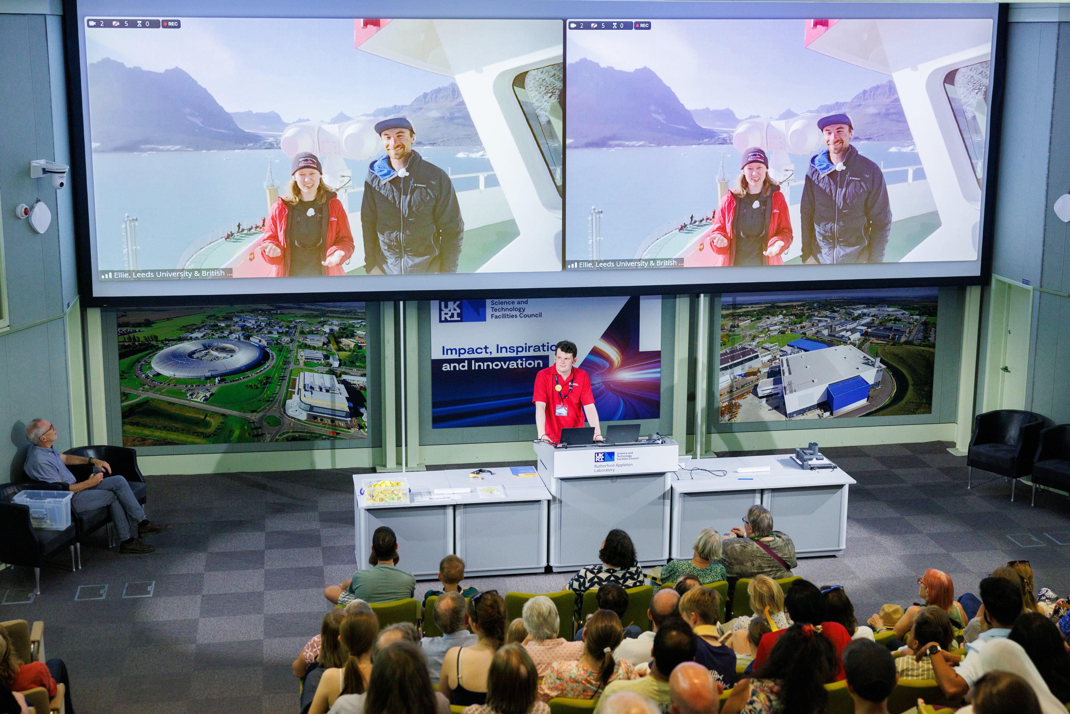 A photo of a video-call between attendees at RAL members of the British Antarctic Survey onboard the RRS Sir David Attenborough during the 2026 solar eclipse
